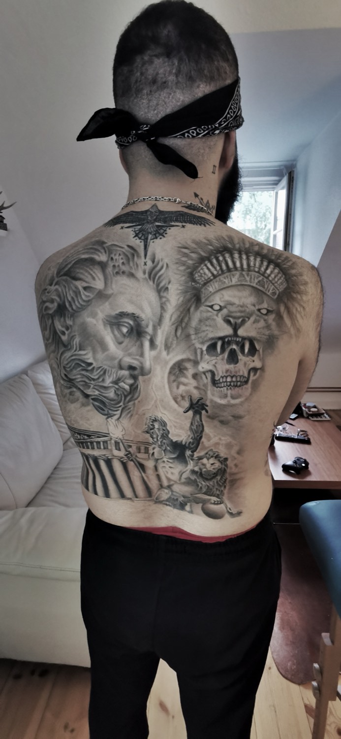 Large piece on the back with Zeus, lion, and skull in black and gray