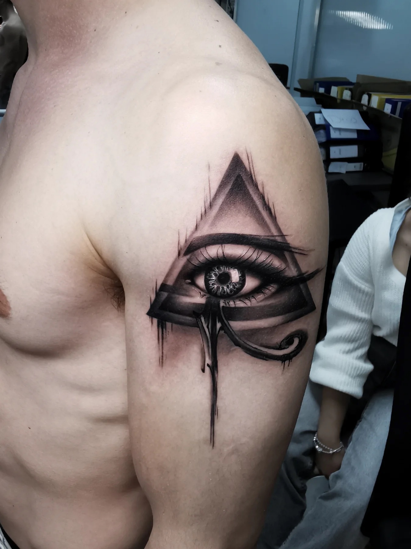 Eye in a triangle on the shoulder